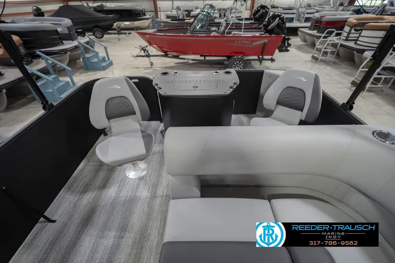 Slide: The Image of 2026 Bennington 21 SF boat interior with gray seating and control panel in showroom. - 18