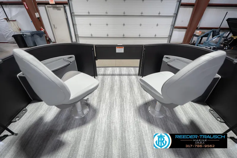 Slide: The Image of 2026 Bennington 21 SF boat interior with two swivel seats in a showroom. - 21