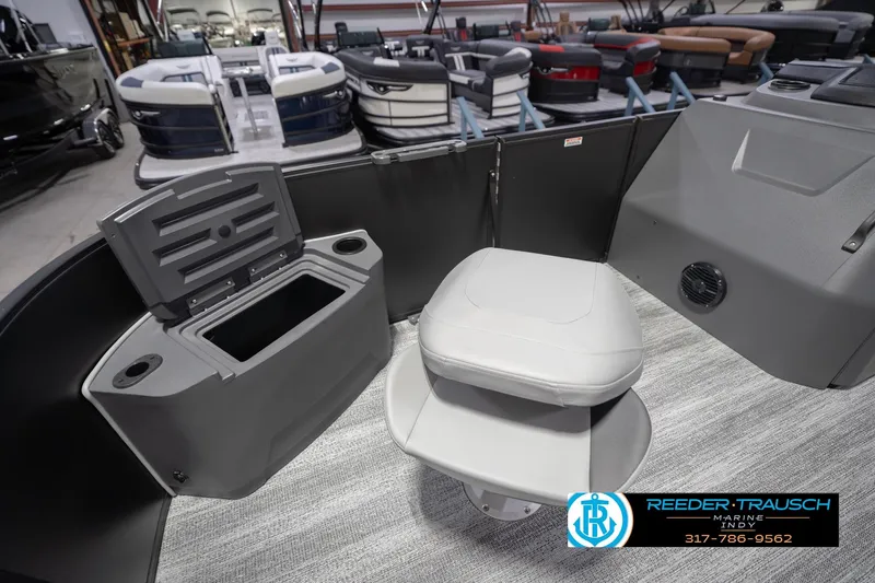 Slide: The Image of 2026 Bennington 21 SF boat interior with seating and storage, displayed at Reeder-Trausch Marine. - 23
