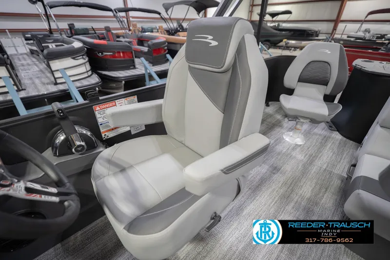 Slide: The Image of Bennington 21 SF 2026 boat interior with gray captain's chair and steering wheel. - 25