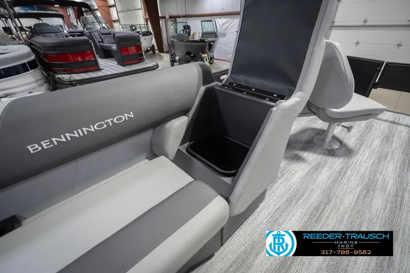 Slide: The Image of 2026 Bennington 21 SF boat interior with storage compartment open, showcasing seating and design. - 27