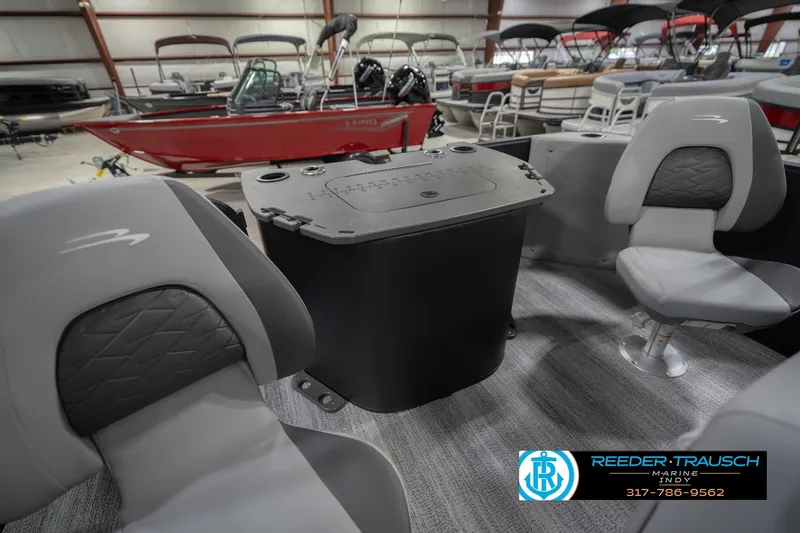 Slide: The Image of 2026 Bennington 21 SF boat interior with gray seating and console, displayed in showroom. - 32