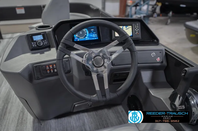 Slide: The Image of 2026 Bennington 21 SF boat dashboard with steering wheel and navigation controls. - 35