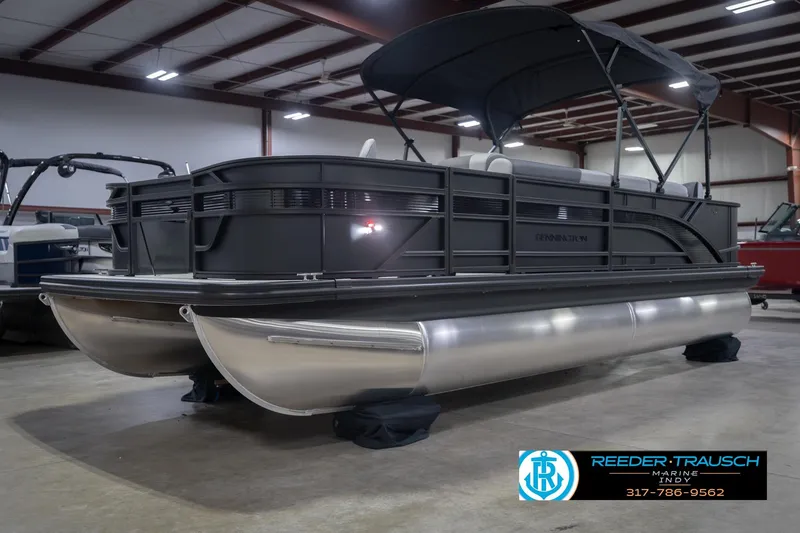 Slide: The Image of 2026 Bennington 21 SF pontoon boat in showroom, featuring sleek design and canopy. - 4