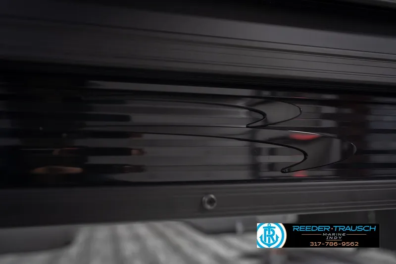 Slide: The Image of 2026 Bennington 21 SF boat detail with sleek black design and Reeder-Trausch Marine logo. - 52