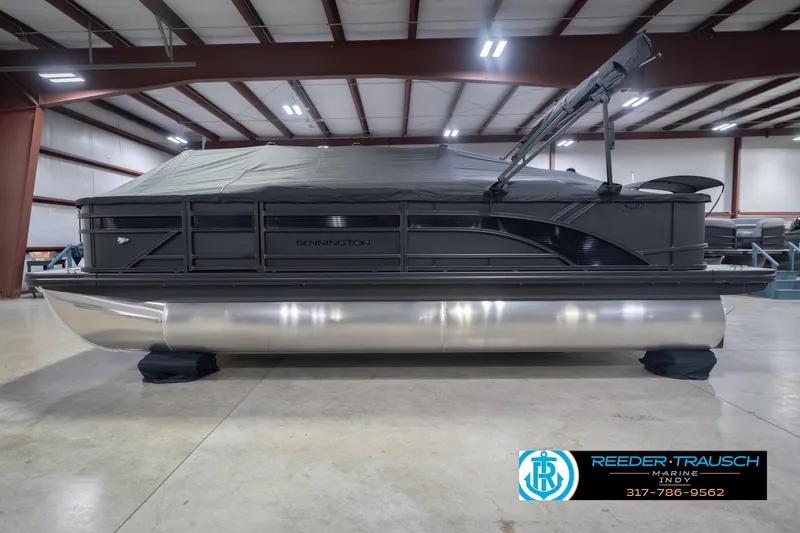Slide: The Image of 2026 Bennington 21 SF pontoon boat in indoor showroom, covered and displayed. - 56