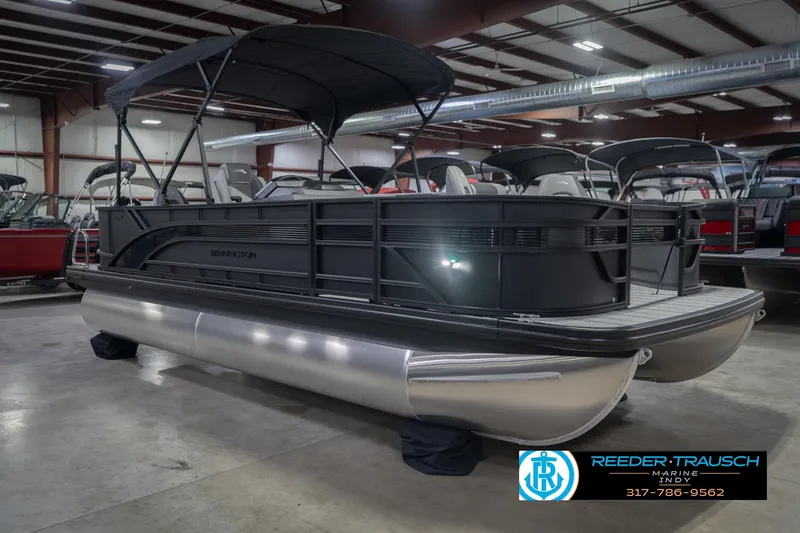 Slide: The Image of 2026 Bennington 21 SF pontoon boat displayed indoors at Reeder Trausch Marine showroom. - 6