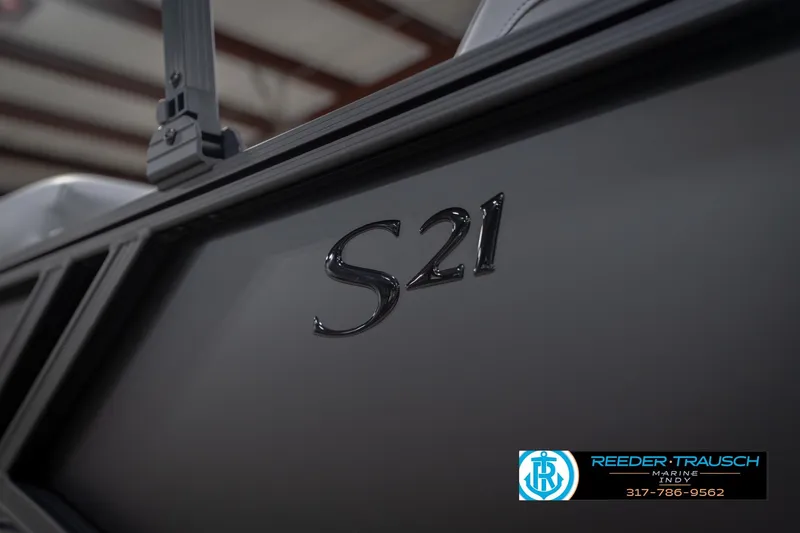 Slide: The Image of 2026 Bennington 21 SF boat detail with S21 emblem, Reeder Trausch Marine logo. - 60