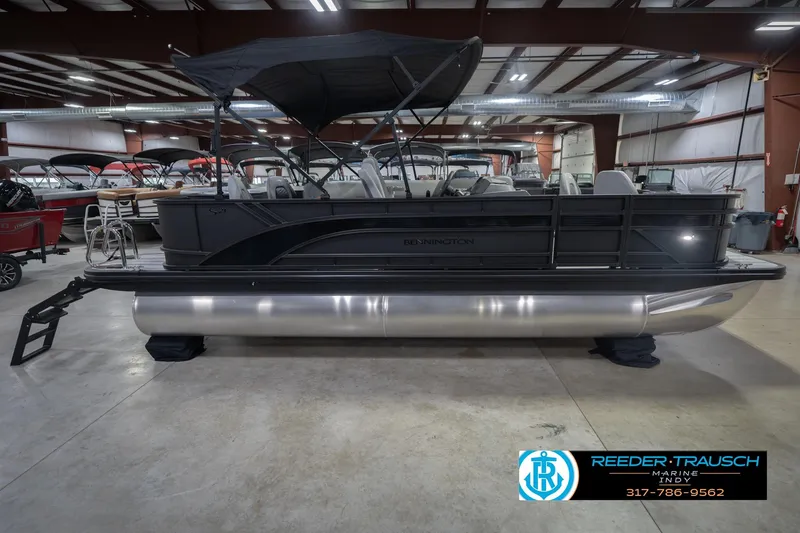 Slide: The Image of 2026 Bennington 21 SF pontoon boat in showroom with canopy and seating. - 7