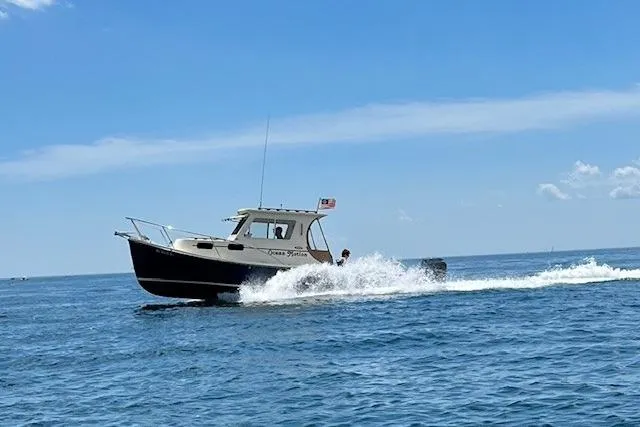 Slide: The Image of 2015 Eastern 248 Islander boat cruising on open water under clear blue sky. - 3