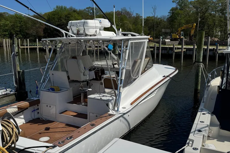 The Image of 2005 Egg Harbor 35' Express boat docked, aerial view, showcasing spacious deck and sleek design. - 0