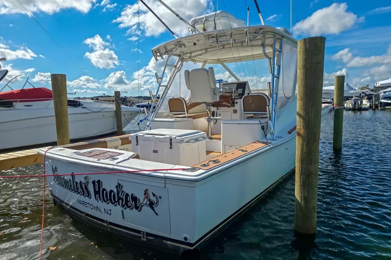 Slide: The Image of 2005 Egg Harbor 35' Express boat docked at marina under blue sky. - 16