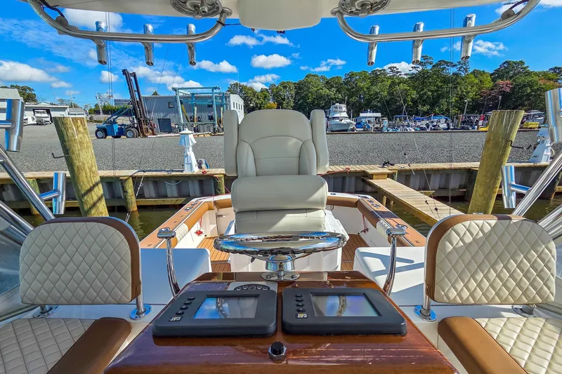 Slide: The Image of Helm of 2005 Egg Harbor 35' Express boat with luxurious seating and control panels. - 17
