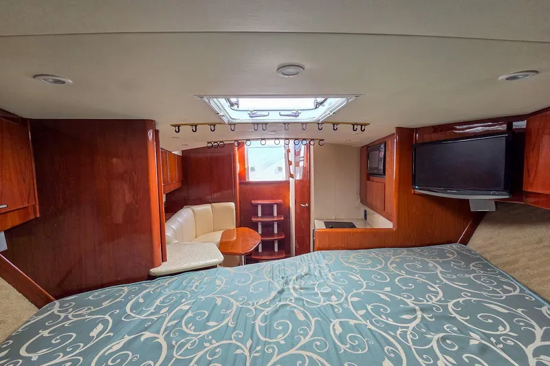 Slide: The Image of Interior of 2005 Egg Harbor 35' Express yacht with bed, seating, and TV. - 19
