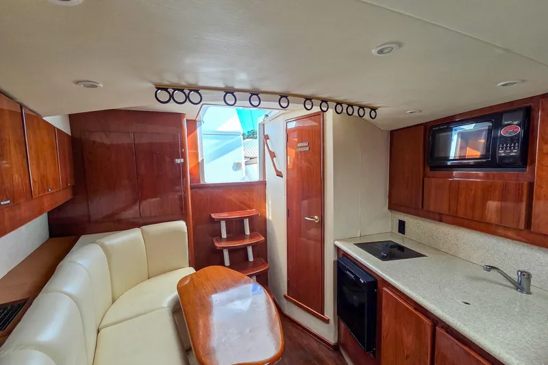 Slide: The Image of Luxurious interior of 2005 Egg Harbor 35' Express yacht with kitchenette and seating area. - 20