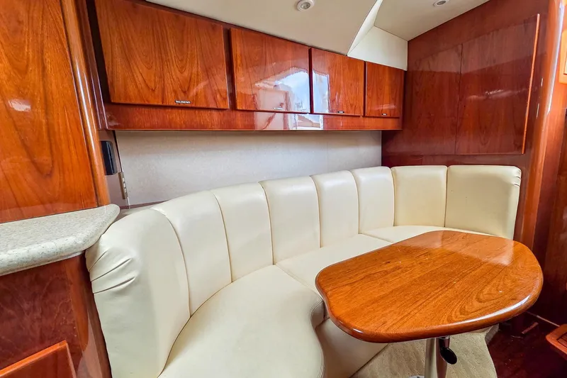 Slide: The Image of Luxurious interior of 2005 Egg Harbor 35' Express with leather seating and wooden cabinetry. - 24