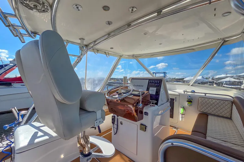 Slide: The Image of 2005 Egg Harbor 35' Express boat helm with Garmin navigation, luxurious seating, and panoramic views. - 29