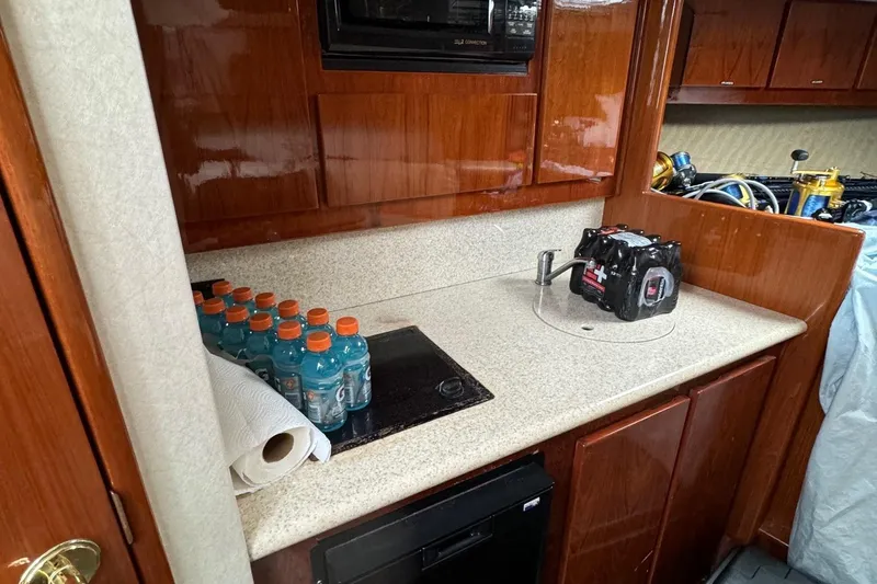 Slide: The Image of 2005 Egg Harbor 35' Express boat docked, featuring "Shameless Hooker" name, under a clear blue sky. - 7