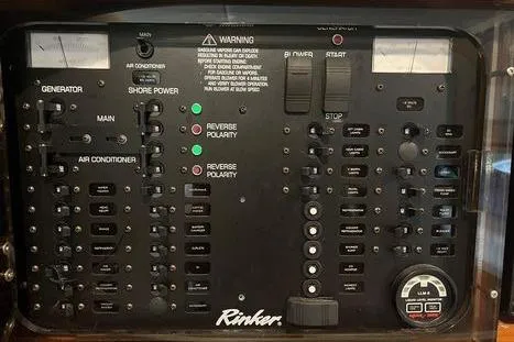 Slide: The Image of Control panel of 2002 Rinker 342 Fiesta Vee boat with various switches and indicators. - 11