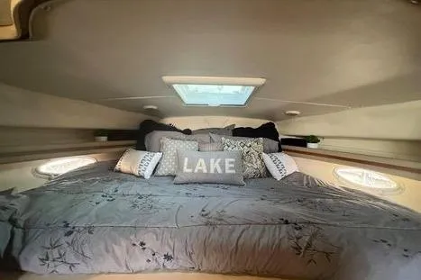 Slide: The Image of Cozy cabin interior of 2002 Rinker 342 Fiesta Vee with decorative pillows and skylight. - 12