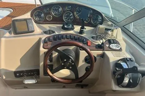 Slide: The Image of 2002 Rinker 342 Fiesta Vee boat dashboard with gauges and controls. - 16
