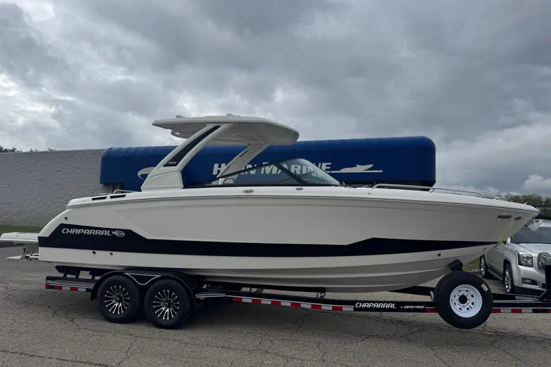The Image of 2026 Chaparral 30 SSX boat on trailer, overcast sky background. - 0