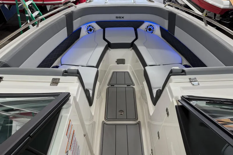 Slide: The Image of 2026 Chaparral 30 SSX boat interior with gray seating and blue LED lighting. - 19