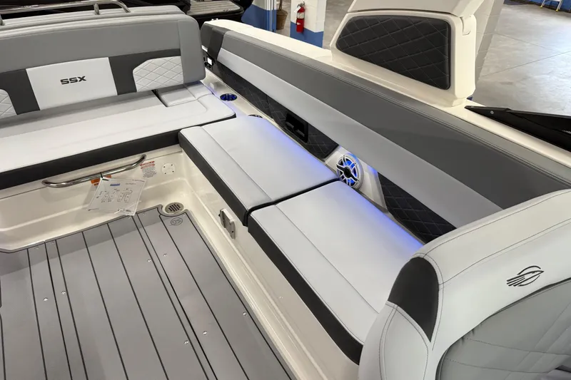 Slide: The Image of 2026 Chaparral 30 SSX boat interior with gray seating and blue LED lighting. - 21