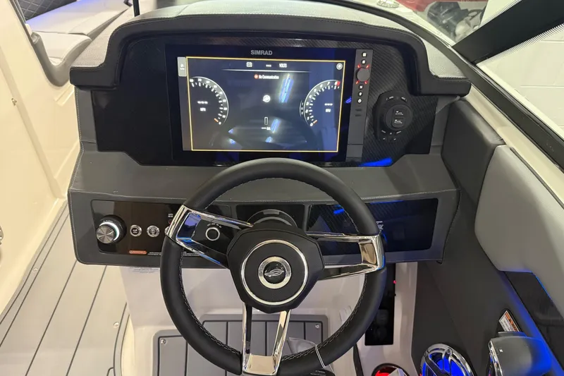 Slide: The Image of 2026 Chaparral 30 SSX boat dashboard with steering wheel and digital display. - 6