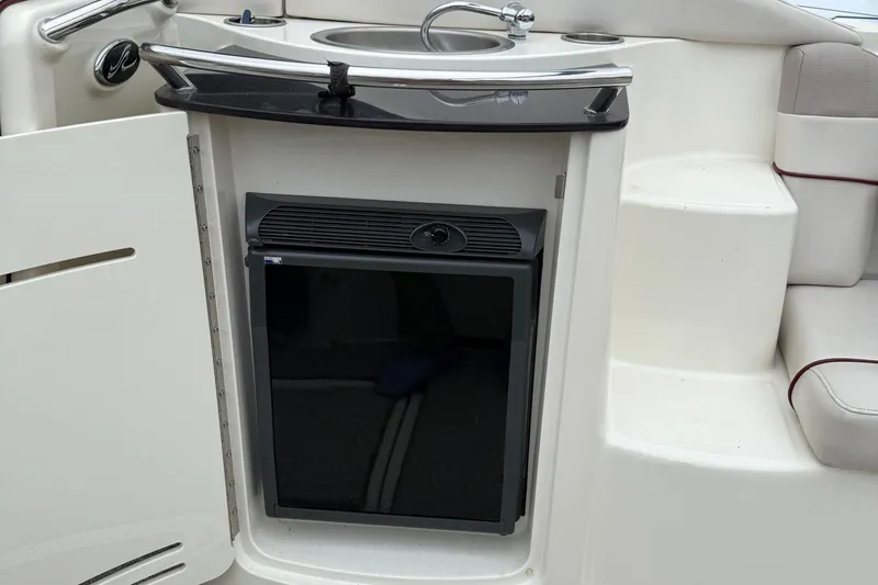 Slide: The Image of 2005 Sea Ray 270 SLX boat interior with mini fridge and sink. - 11