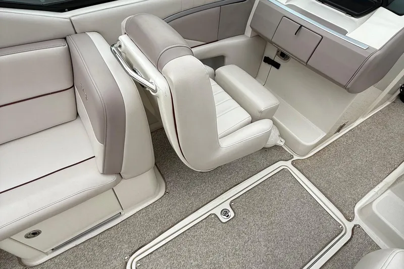 Slide: The Image of 2005 Sea Ray 270 SLX interior with beige seating and carpeted flooring. - 14