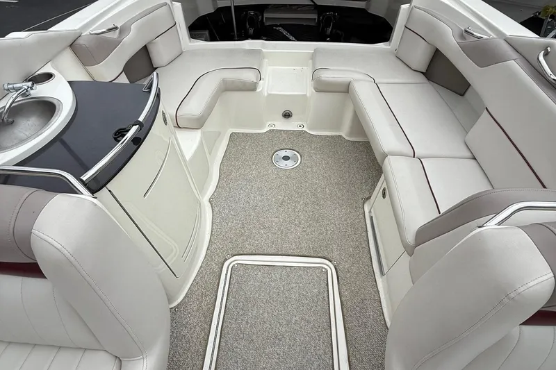 Slide: The Image of Luxurious interior of a 2005 Sea Ray 270 SLX boat with plush seating and a compact sink. - 15