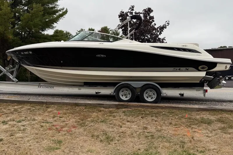 Slide: The Image of 2005 Sea Ray 270 SLX boat on trailer, parked outdoors. - 3