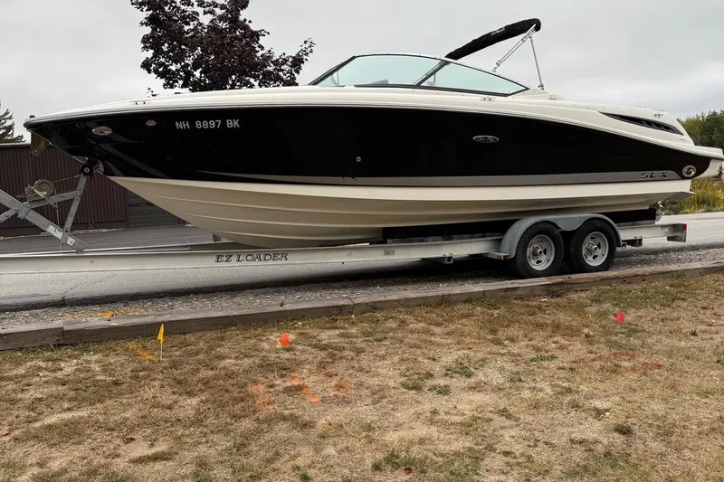 Slide: The Image of 2005 Sea Ray 270 SLX boat on trailer, parked outdoors. - 5