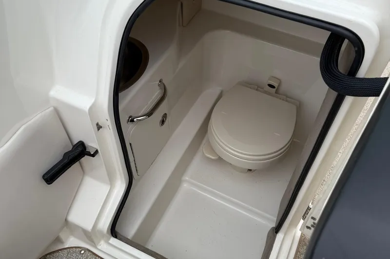 Slide: The Image of 2005 Sea Ray 270 SLX boat interior with compact marine toilet. - 6