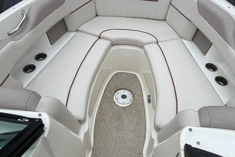 Slide: The Image of 2005 Sea Ray 270 SLX boat interior with white seating and cup holders. - 7
