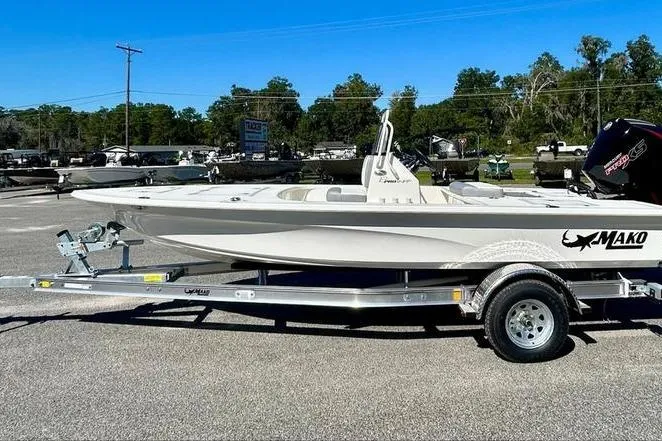 The Image of 2026 Mako 18 Pro Skiff boat on trailer in outdoor setting. - 0