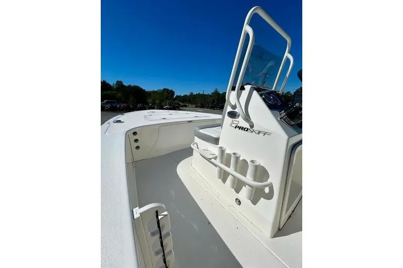 Slide: The Image of 2026 Mako 18 Pro Skiff boat interior with rod holders and console. - 11