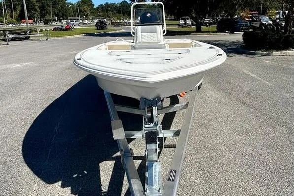 Slide: The Image of 2026 Mako 18 Pro Skiff boat on trailer in parking lot. - 2