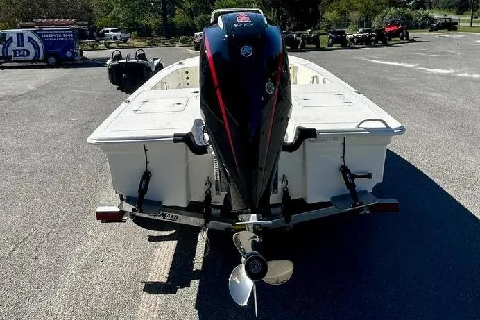 Slide: The Image of 2026 Mako 18 Pro Skiff boat with outboard motor, parked in a lot. - 6