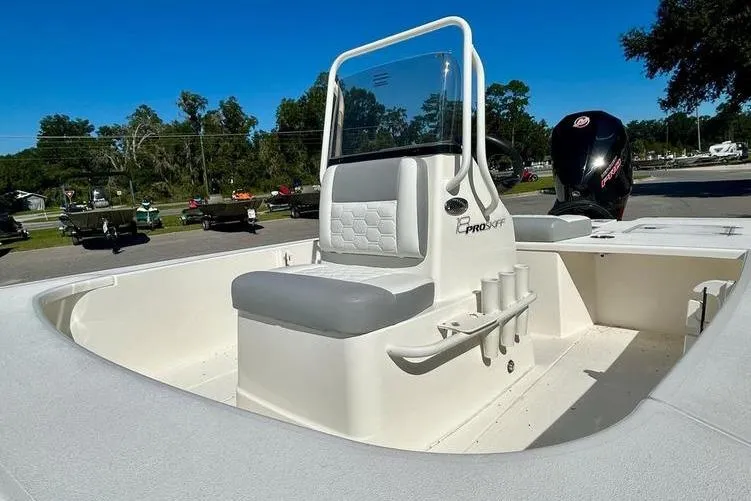 Slide: The Image of 2026 Mako 18 Pro Skiff boat with center console and seating, parked outdoors. - 8