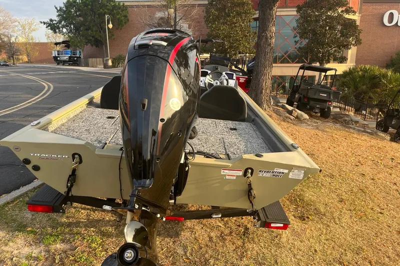 Slide: The Image of 2026 Tracker Pro Team 190 boat with outboard motor, parked outdoors. - 5