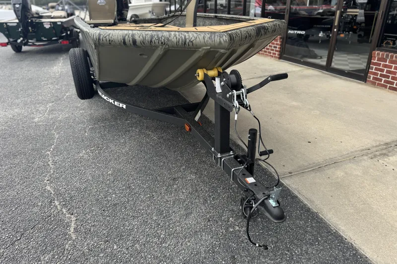 Slide: The Image of 2026 Tracker Grizzly 1650 T Prairie Wings Edition boat on trailer, parked outside. - 11