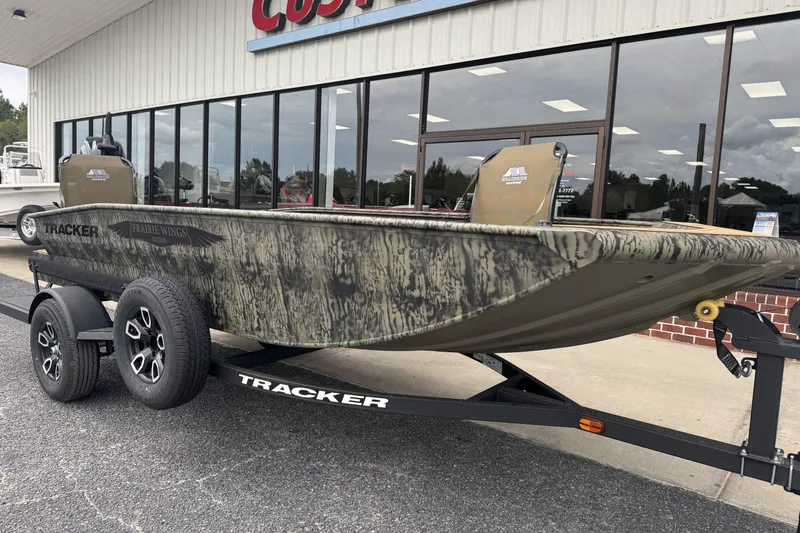 Slide: The Image of 2026 Tracker Grizzly 1650 T Prairie Wings Edition boat on trailer, outside dealership. - 12