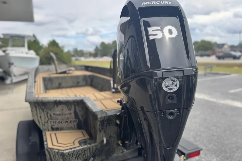 Slide: The Image of 2026 Tracker Grizzly 1650 T Prairie Wings Edition boat with camouflage design on trailer. - 14