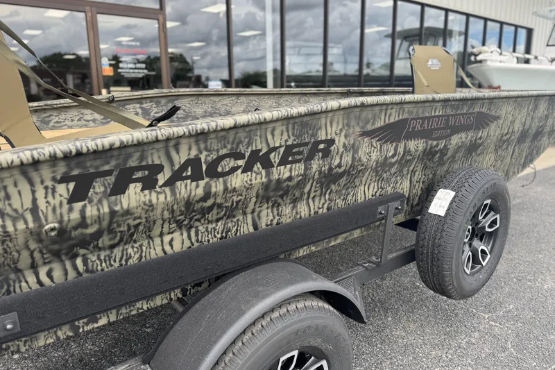Slide: The Image of 2026 Tracker Grizzly 1650 T Prairie Wings Edition boat on trailer, camo design. - 3