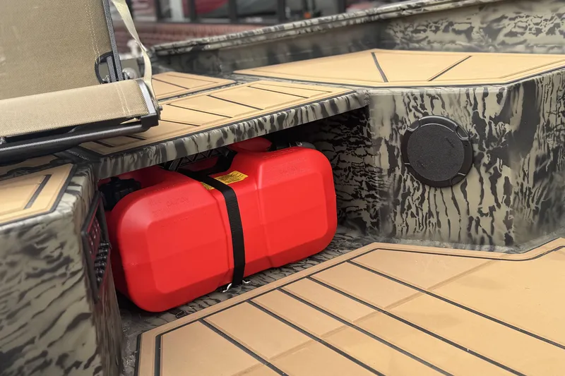 Slide: The Image of 2026 Tracker Grizzly 1650 T Prairie Wings Edition boat interior with red fuel tank. - 8