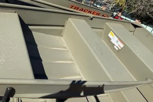 Slide: The Image of 2026 Tracker Grizzly 10 Jon boat interior with seating and storage compartments. - 2
