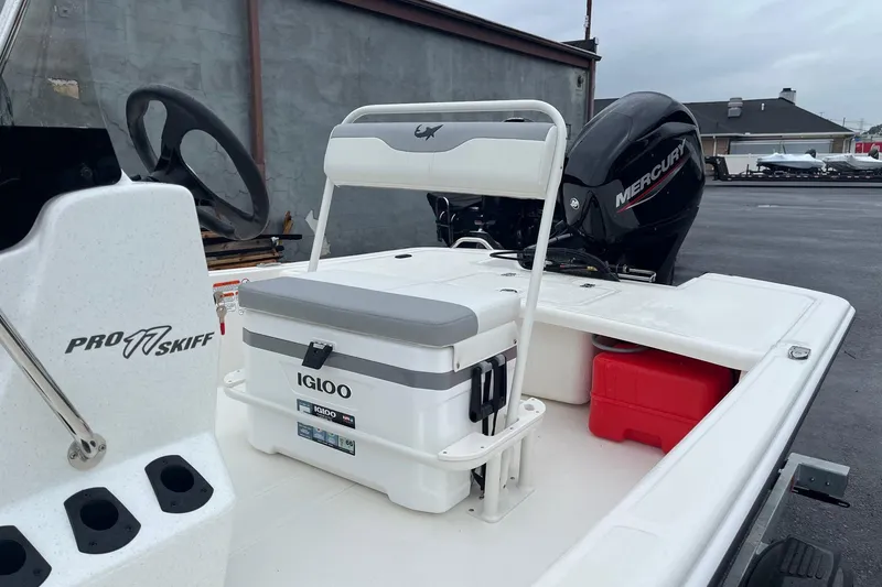 Slide: The Image of 2026 Mako Pro Skiff 17 CC boat with Igloo cooler and Mercury engine. - 2