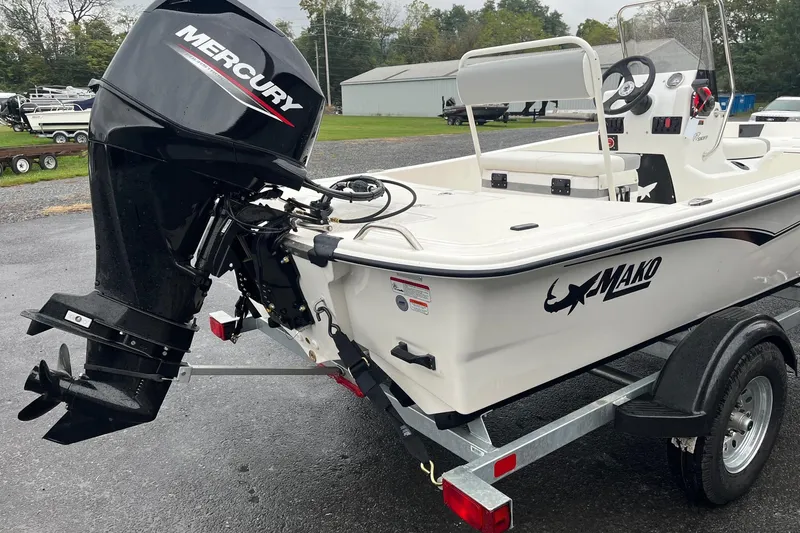 Slide: The Image of 2026 Mako Pro Skiff 17 CC boat with Mercury outboard motor on trailer. - 4